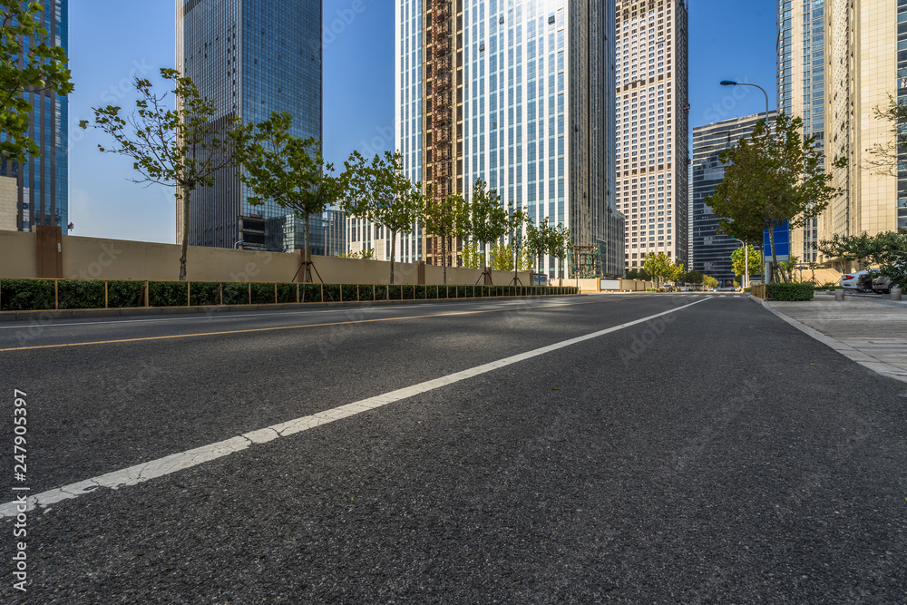 cityscape and skyline of shanghai from empty asphalt road.