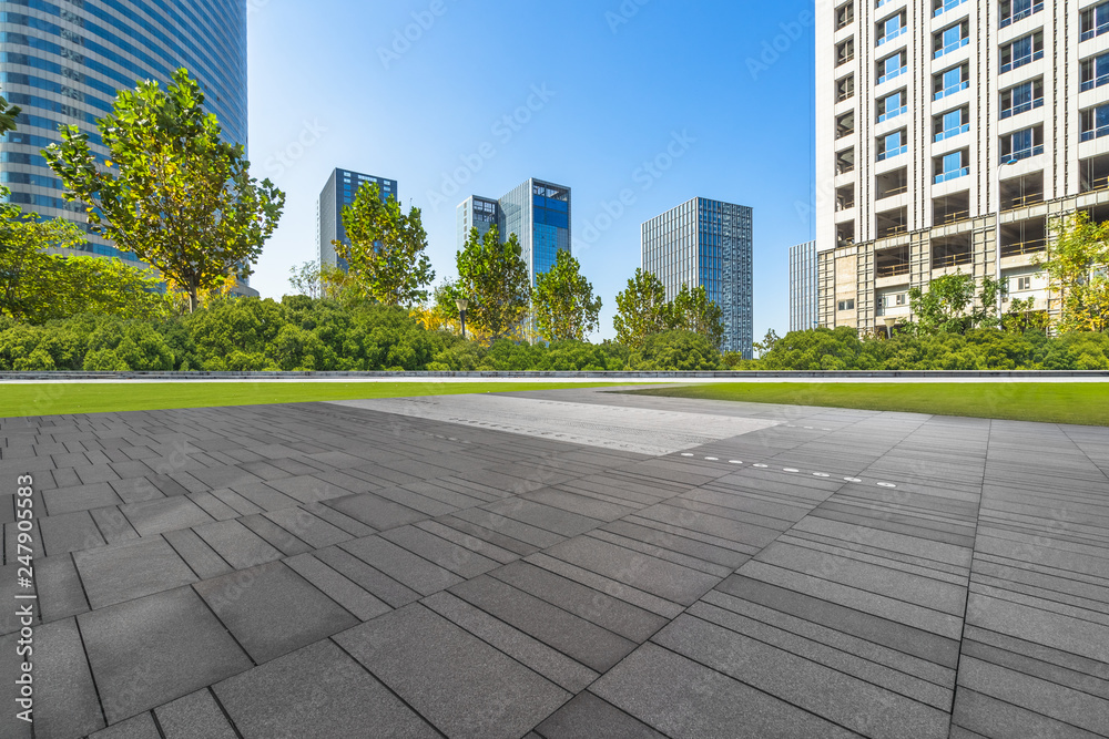 empty pavement and modern buildings in city.