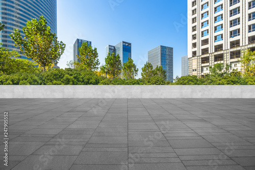 empty pavement and modern buildings in city.