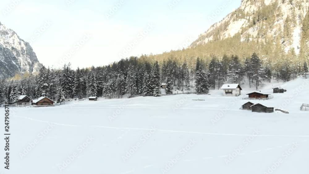 Aerial Drone View of a Snowy Winter Valley and Chalets Aerial Drone View of a Snowy Winter Valley and Chalets
