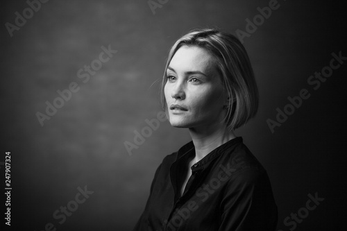 Dramatic black and white portrait of a beautiful woman on a dark background