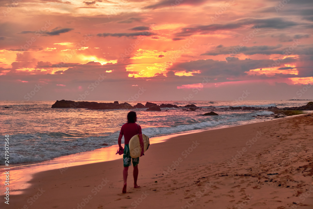 Stunning sunset on the beach overlooking the ocean and the waves. 