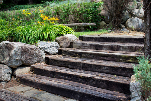 wooden stairs with boulders and golden flowers