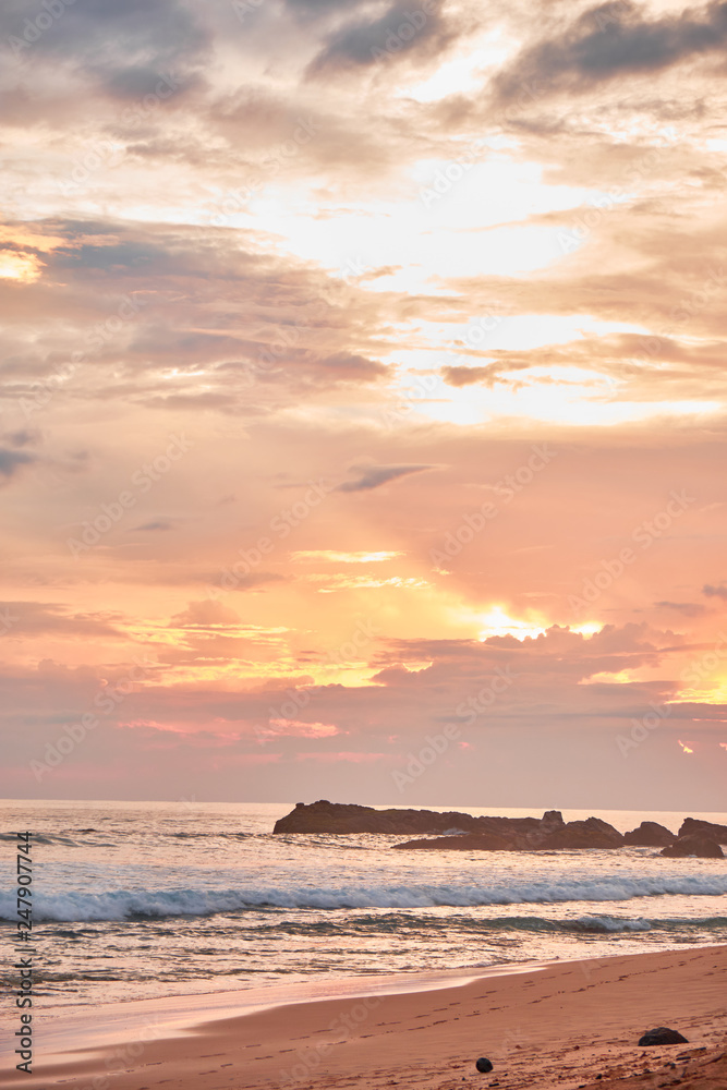 Stunning sunset on the beach overlooking the ocean and the waves. Stunning sunset on the beach overlooking the ocean and the waves.