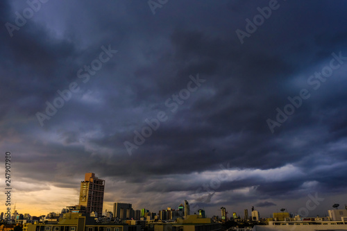 Sticker Raining cloud over skyscraper of modern city building