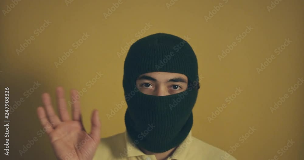 Man in balaclava is waving Man in balaclava is waving