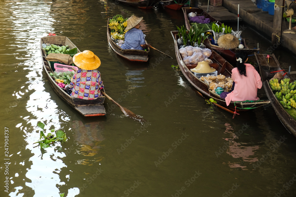 Traditional floating market of Damnoen Saduak with food and drink goods tourist attraction