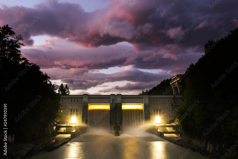 Small hydro dam electricity power station with beautiful sunset in Medvode, Slovenia