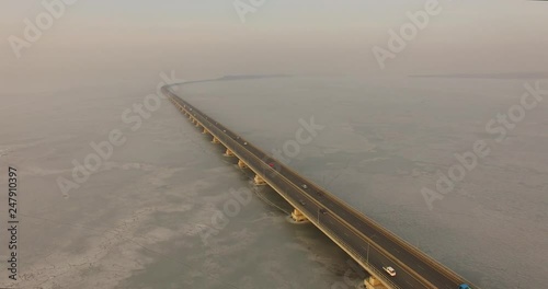 Landscape with a field of ice of the Amur Bay and the bridge Sedanka-De Vries. Vladivostok, Russia
