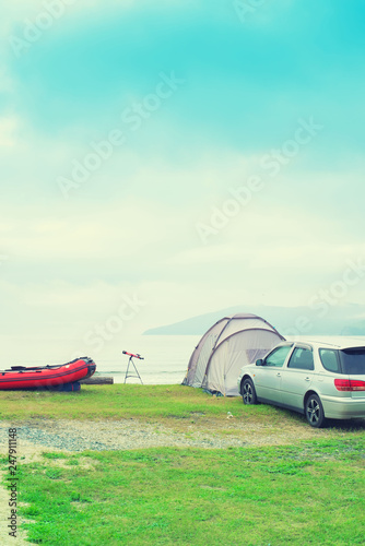 Seascape summer travel machine tent rubber boat Coastline horizon sky with clouds