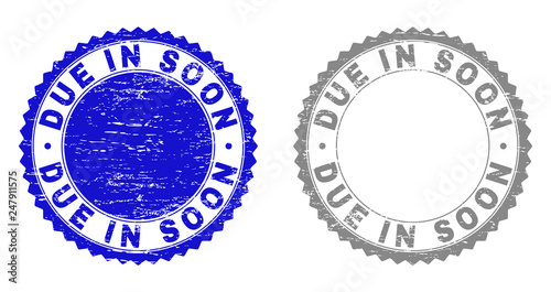 Grunge DUE IN SOON stamp seals isolated on a white background. Rosette seals with distress texture in blue and grey colors. Vector rubber stamp imitation of DUE IN SOON title inside round rosette.