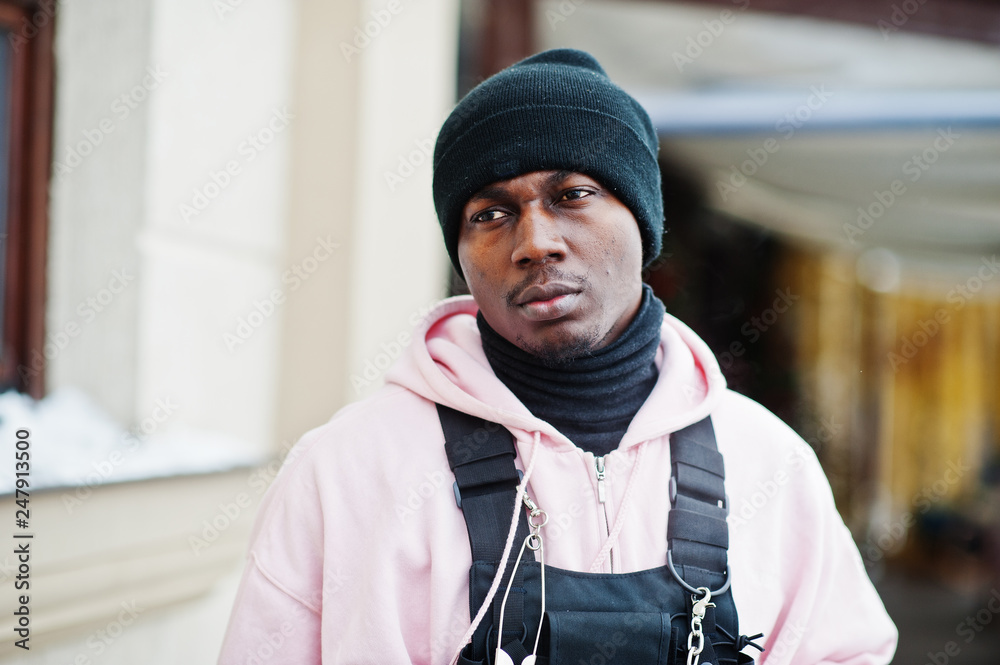 Close up head of stylish urban style african american man in pink hoodie  and black hat posed. Stock Photo | Adobe Stock