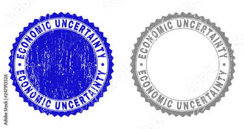 Grunge ECONOMIC UNCERTAINTY stamp seals isolated on a white background. Rosette seals with grunge texture in blue and gray colors.