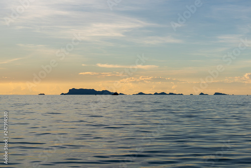 Beautiful beach sunset with blue sea and golden light sky  cloud background