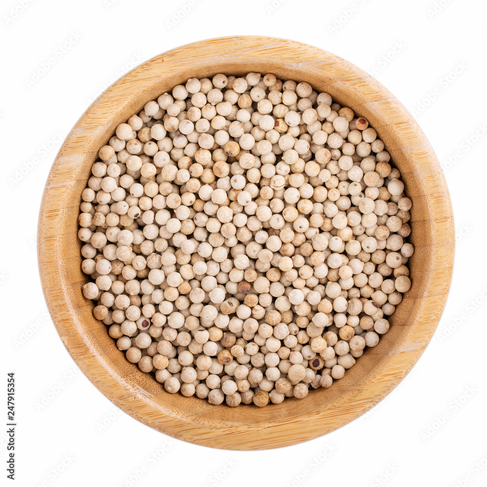 White pepper. Hot peppercorn in wooden bowl isolated on white. Top view. White pepper. Hot peppercorn in wooden bowl isolated on white. Top view.