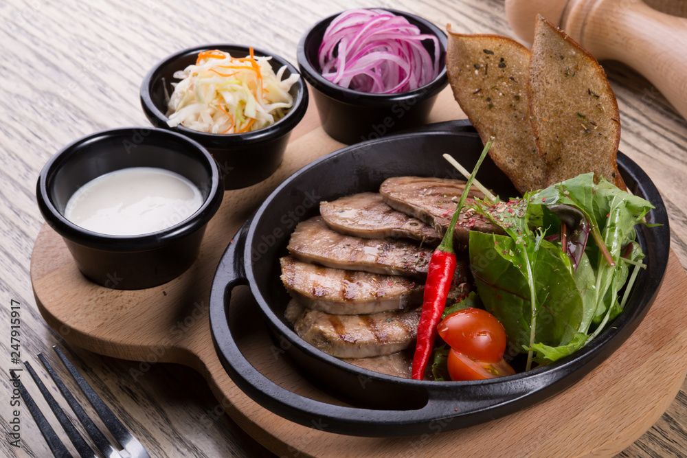 Fired beef tongue served with chili pepper Fired beef tongue served with chili pepper