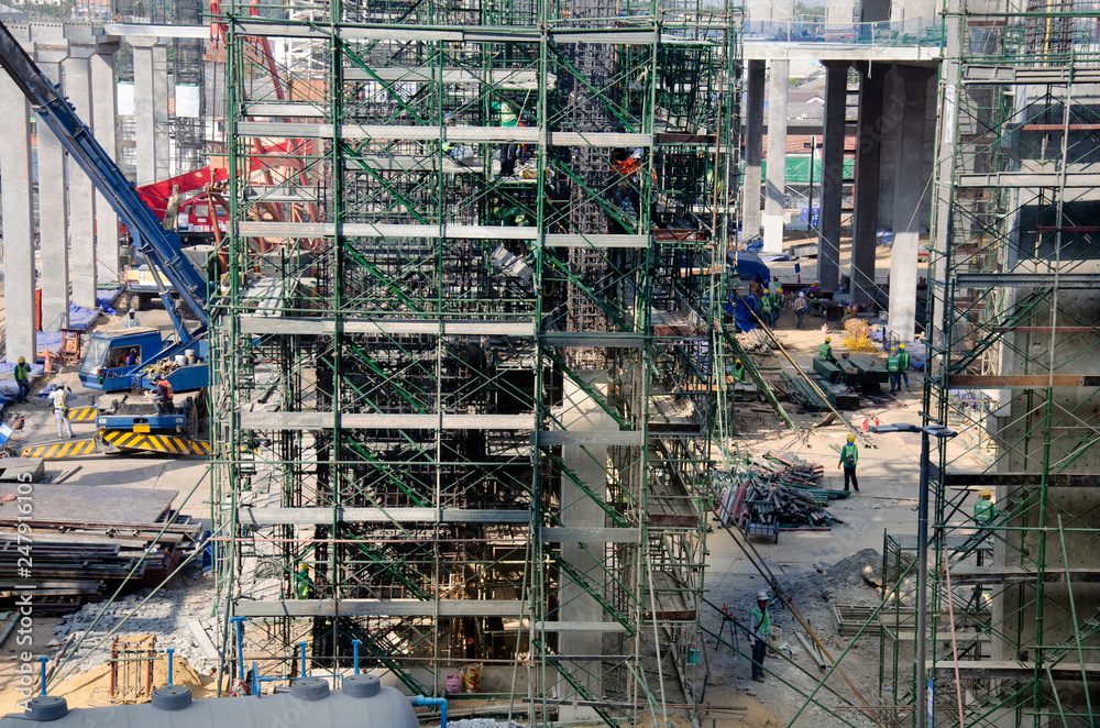 Asian people and thai workers with heavy machinery working builder new building at construction site high-rise building on scaffold at Bangkok, Thailand.