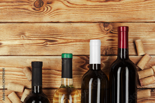 bottle of wine over wooden background