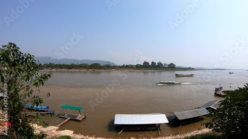 Golden triangle in Thailand: long tail boats on the Mekong river. Video is moving to the left. photo