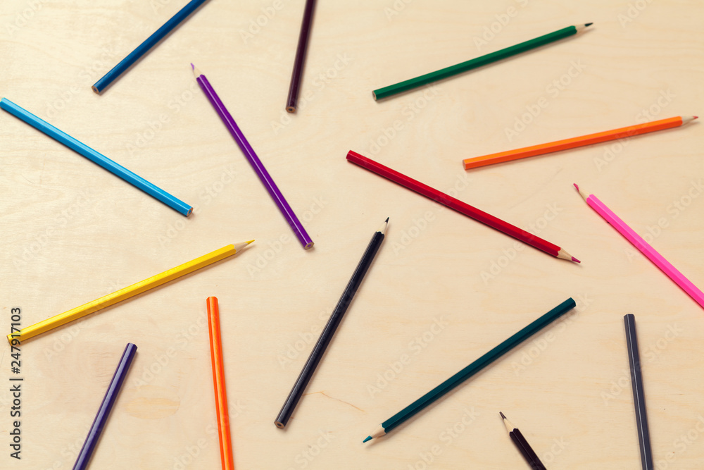 Colorful pencils arrangement on grey background close up Colorful pencils arrangement on grey background close up