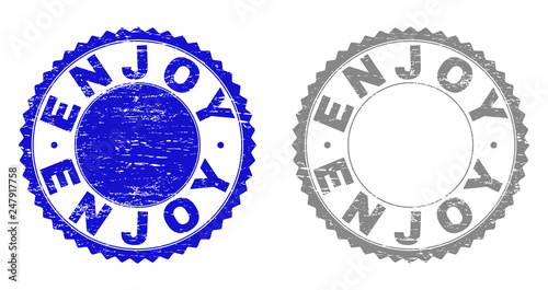 Grunge ENJOY stamp seals isolated on a white background. Rosette seals with grunge texture in blue and gray colors. Vector rubber stamp imprint of ENJOY label inside round rosette.