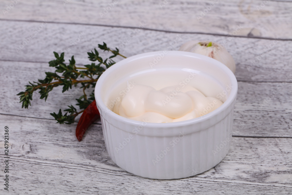 Mayonnaise sauce in the white bowl served thyme and garlic Mayonnaise sauce in the white bowl served thyme and garlic