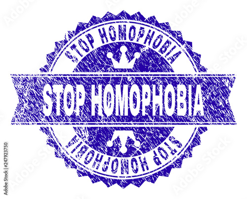 STOP HOMOPHOBIA rosette stamp seal watermark with grunge texture. Designed with round rosette, ribbon and small crowns. Blue vector rubber watermark of STOP HOMOPHOBIA caption with dirty texture.