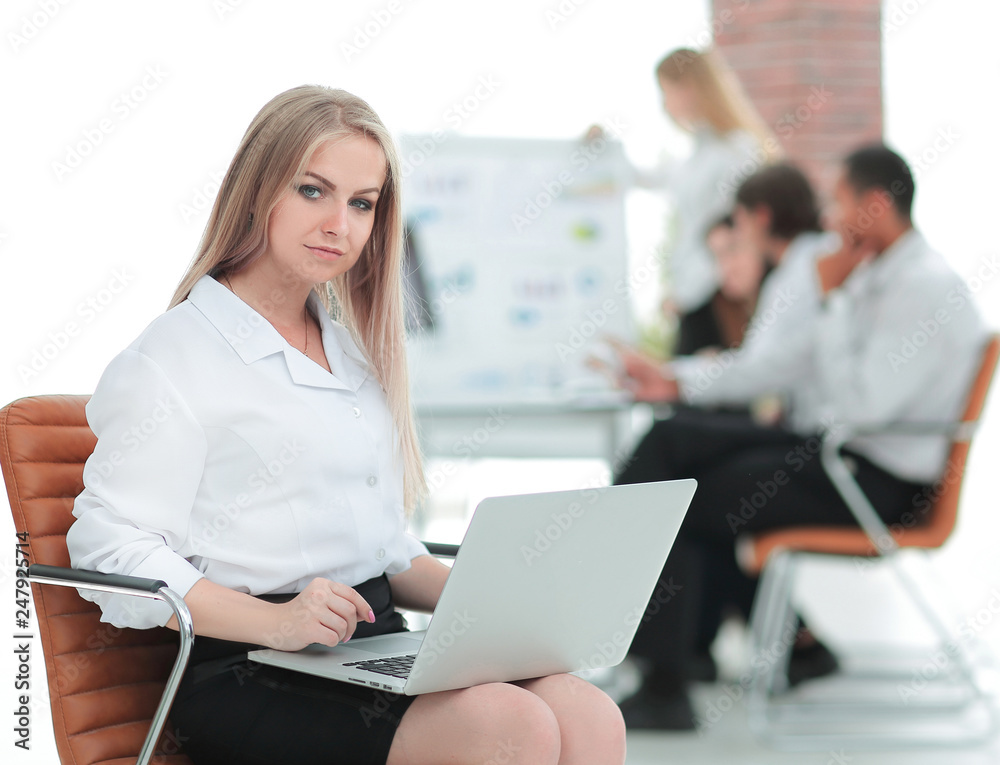 Executive business woman with a laptop on blurred background Executive business woman with a laptop on blurred background