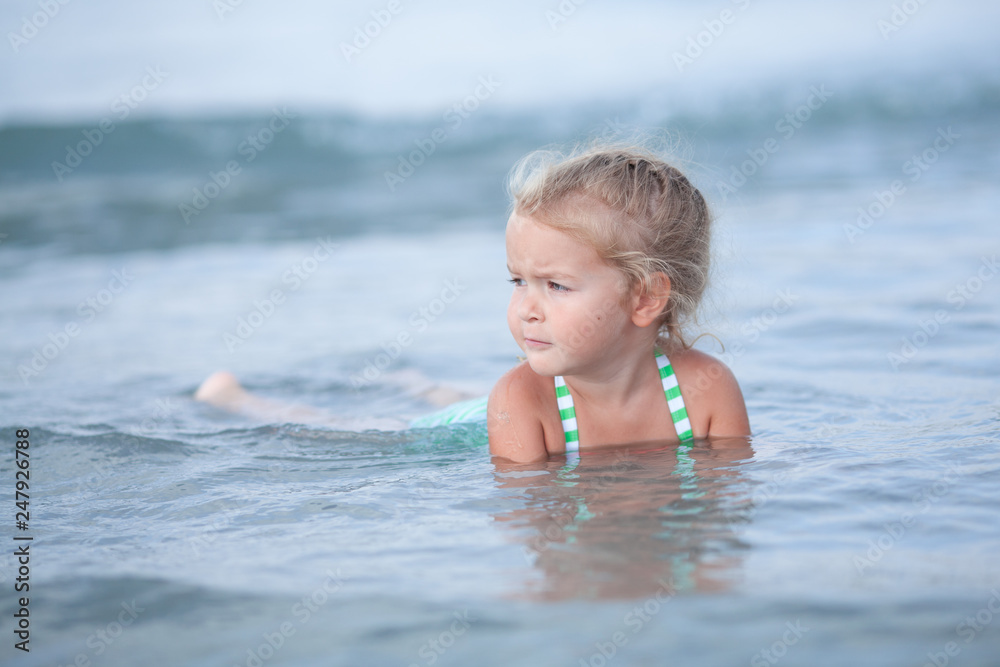 Little cute happy girl swims in the sea, Spain Little cute happy girl swims in the sea, Spain