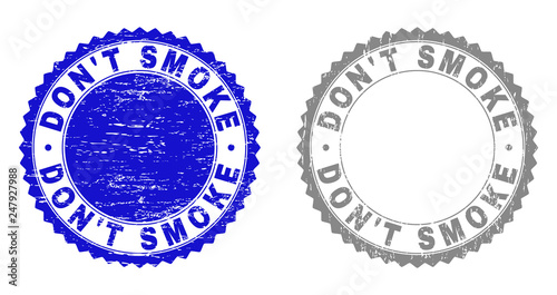 Grunge DON'T SMOKE stamp seals isolated on a white background. Rosette seals with grunge texture in blue and grey colors. Vector rubber stamp imitation of DON'T SMOKE tag inside round rosette.