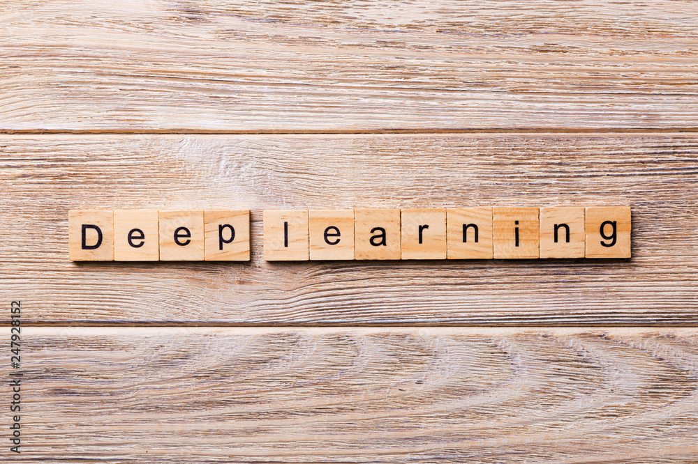 Fototapeta premium Deep Learning word written on wood block. Deep Learning text on wooden table for your desing, concept