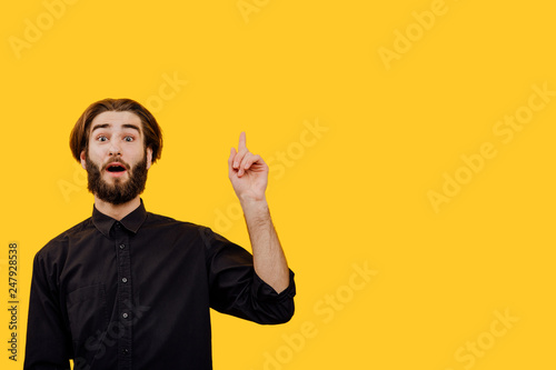 Thinking man having idea. evrika,  Closeup portrait intelligent  young man who just came up with an idea aha, isolated yellow background. Positive emotion facial expression feeling, copy space photo