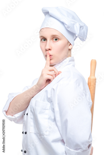 the chef hides the rolling pin behind his back and shows a finger gesture quieter, a portrait on a white background is isolated
