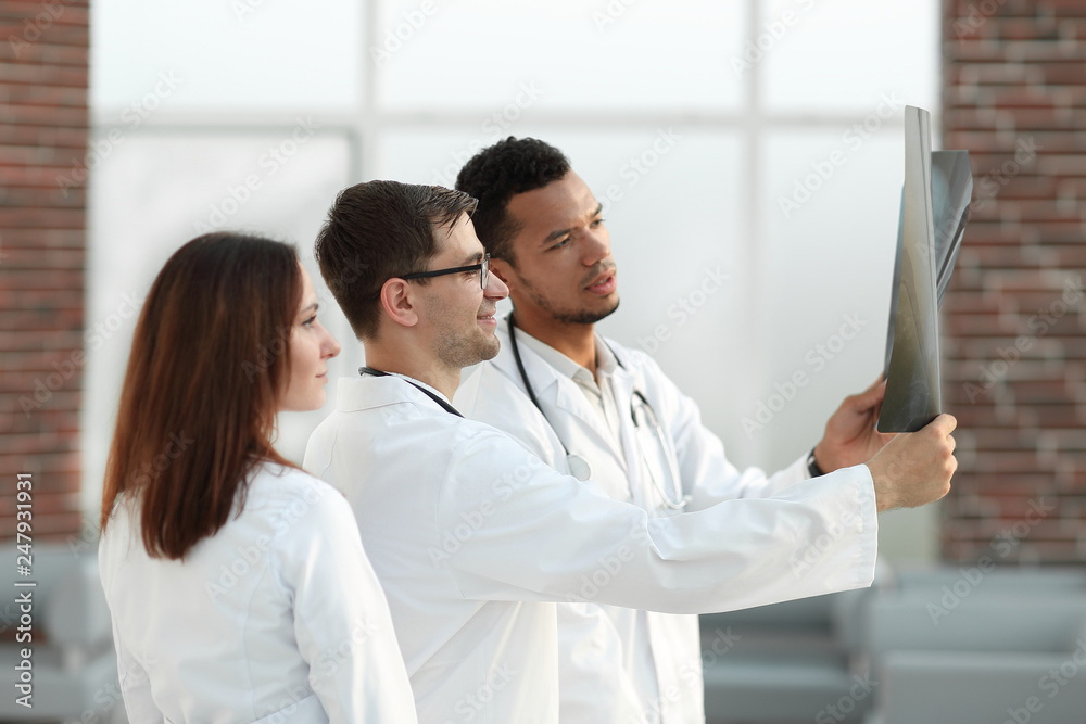 group of medical doctors discussing the patient's x-ray. group of medical doctors discussing the patient's x-ray.