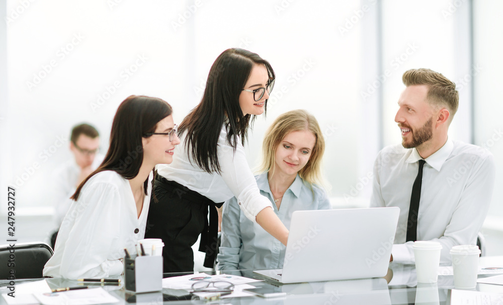 businesswoman pointing to the laptop screen during a meeting with the business team businesswoman pointing to the laptop screen during a meeting with the business team