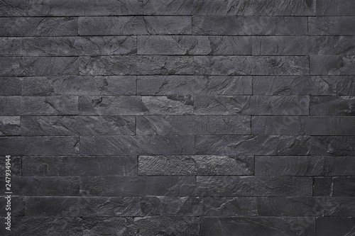 Black slate stone texture background, pattern of wall rocks in natural pattern with high resolution for design art work.