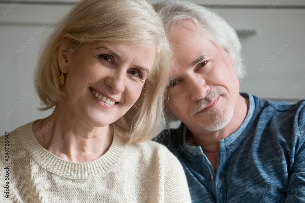 Close up portrait of aged couple smiling looking at camera Close up portrait of aged couple smiling looking at camera