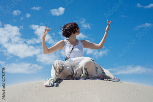 Woman sits on the sand and meditates