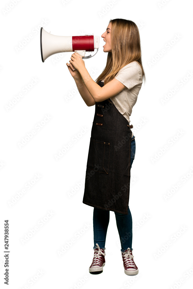 Full body Young woman with apron shouting through a megaphone to announce something in lateral position on isolated background Full body Young woman with apron shouting through a megaphone to announce something in lateral position on isolated background