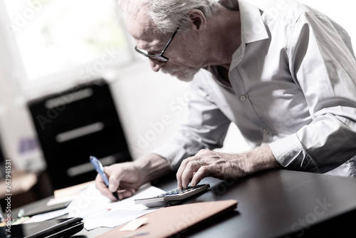 Senior businessman working on business report © thodonal