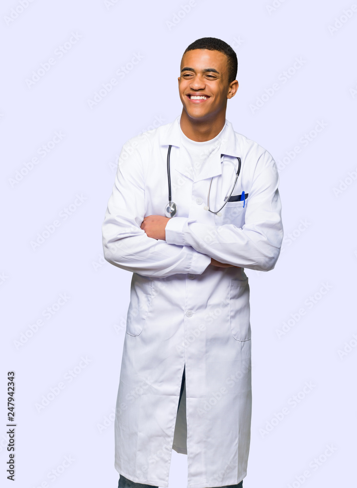 Young afro american man doctor happy and smiling on isolated background Young afro american man doctor happy and smiling on isolated background