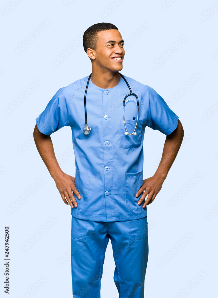 Surgeon doctor man posing with arms at hip and laughing on isolated background Surgeon doctor man posing with arms at hip and laughing on isolated background