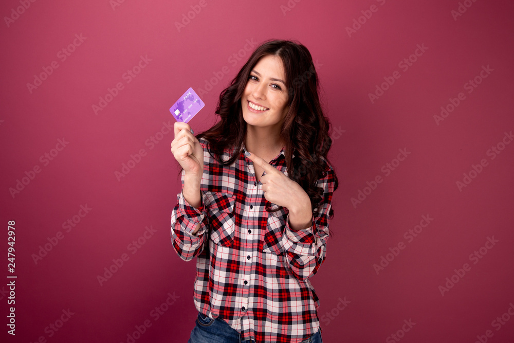 Happy woman hold credit card. Pink background isolated Happy woman hold credit card. Pink background isolated