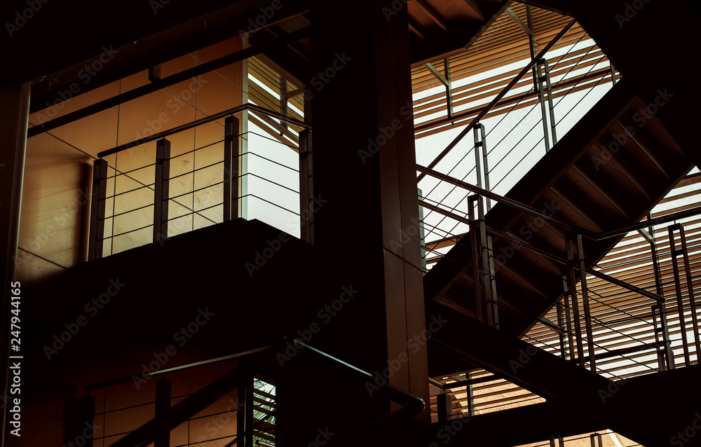 Obraz premium Building interior with stairs in the dusk