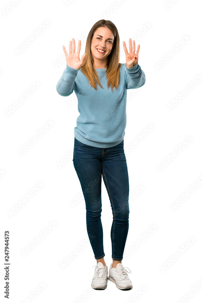 Full body of Blonde woman with blue shirt counting nine with fingers on white background Full body of Blonde woman with blue shirt counting nine with fingers on white background