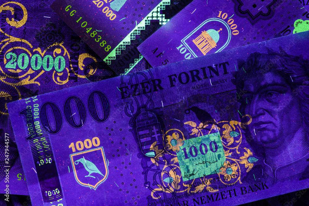 Different Hungarian banknotes in UV light, 1-10-20 thousand HUF.  Fluorescent motives are clearly visible. Europe Hungary. Stock Photo |  Adobe Stock