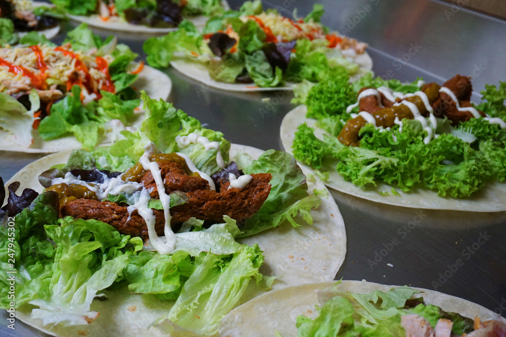 Sandwich wrap with cheese shredded lettuce salad meat tomato satay sauce peanut butter chicken delicious healthy food fast food Sandwich wrap with cheese shredded lettuce salad meat tomato satay sauce peanut butter chicken delicious healthy food fast food