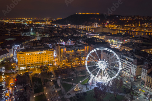Budapest, Hungary - Illuminated ferris wheel at Elisabeth Square at the centre of Budapest with Statue of Liberty, Elisabeth Bridge and other famous landmarks by night