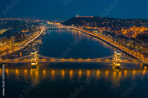 Fototapeta Naklejka Na Ścianę i Meble -  Budapest, Hungary - Aerial skyline view of Budapest at blue hour with illuminated Szechenyi Chain Bridge, Elisabeth Bridge, Citadel taken from above River Daube