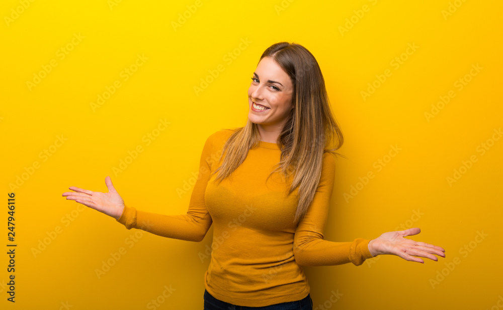 Young woman on yellow background proud and self-satisfied in love yourself concept Young woman on yellow background proud and self-satisfied in love yourself concept